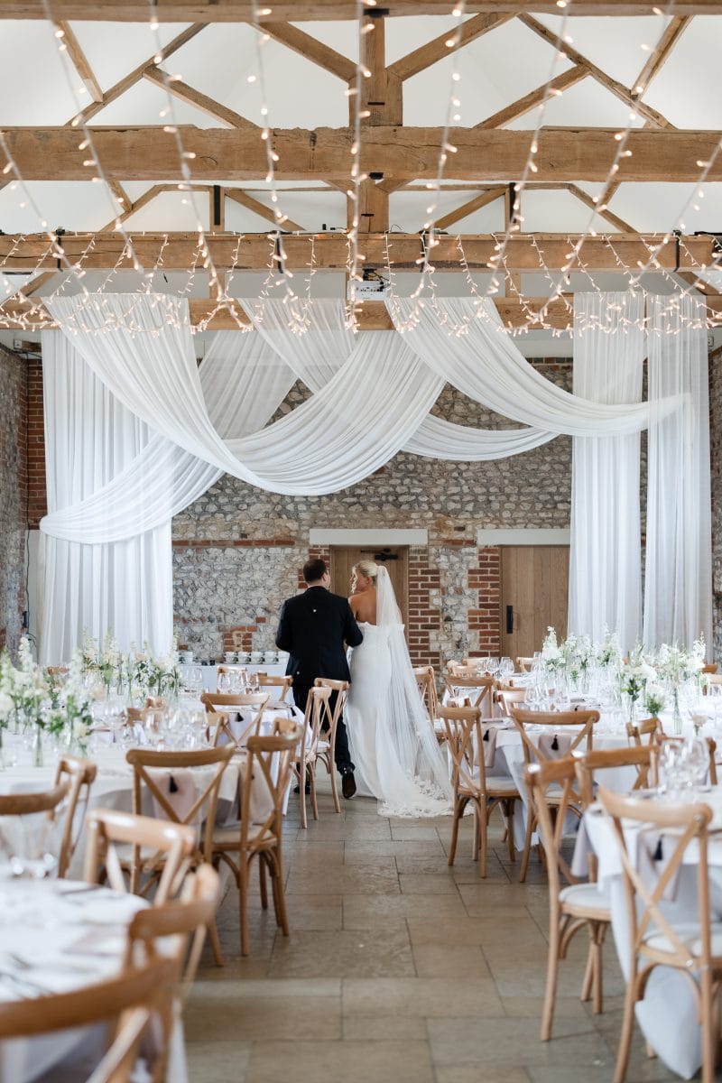 Couple walking through barn
