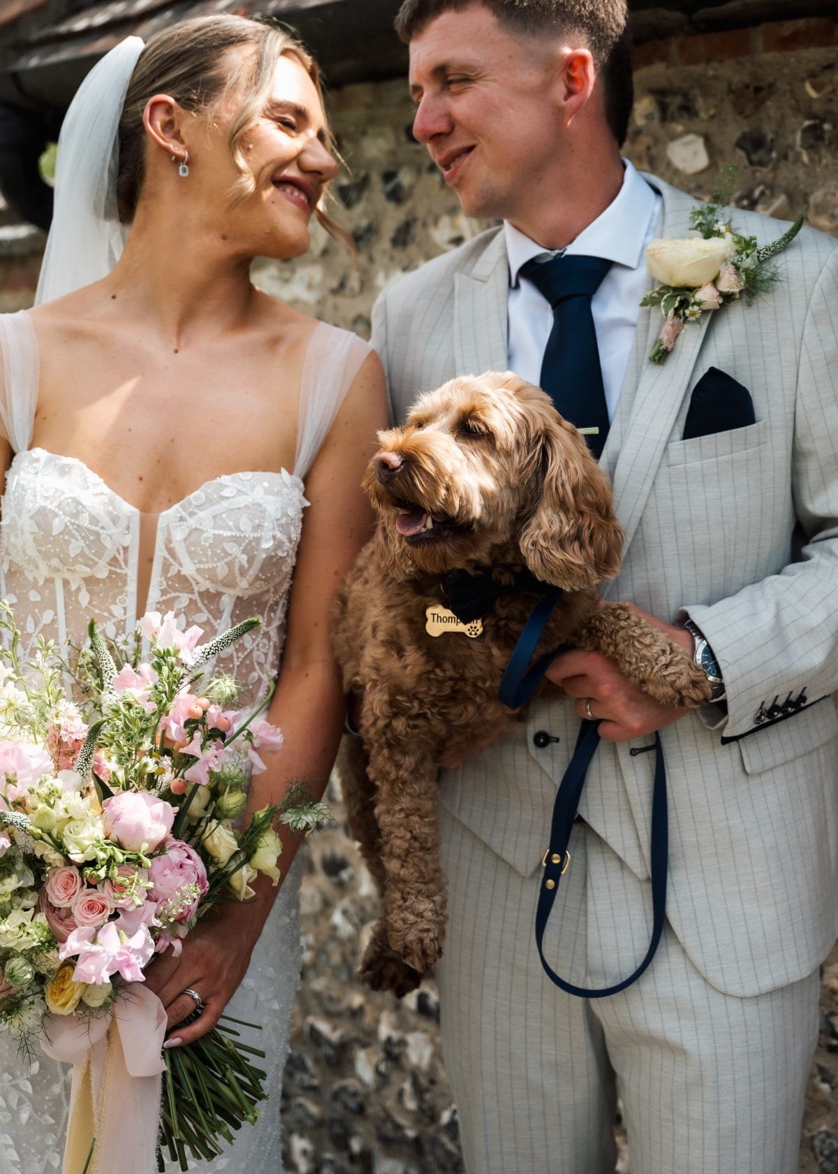 Couple with their dog on their wedding day
