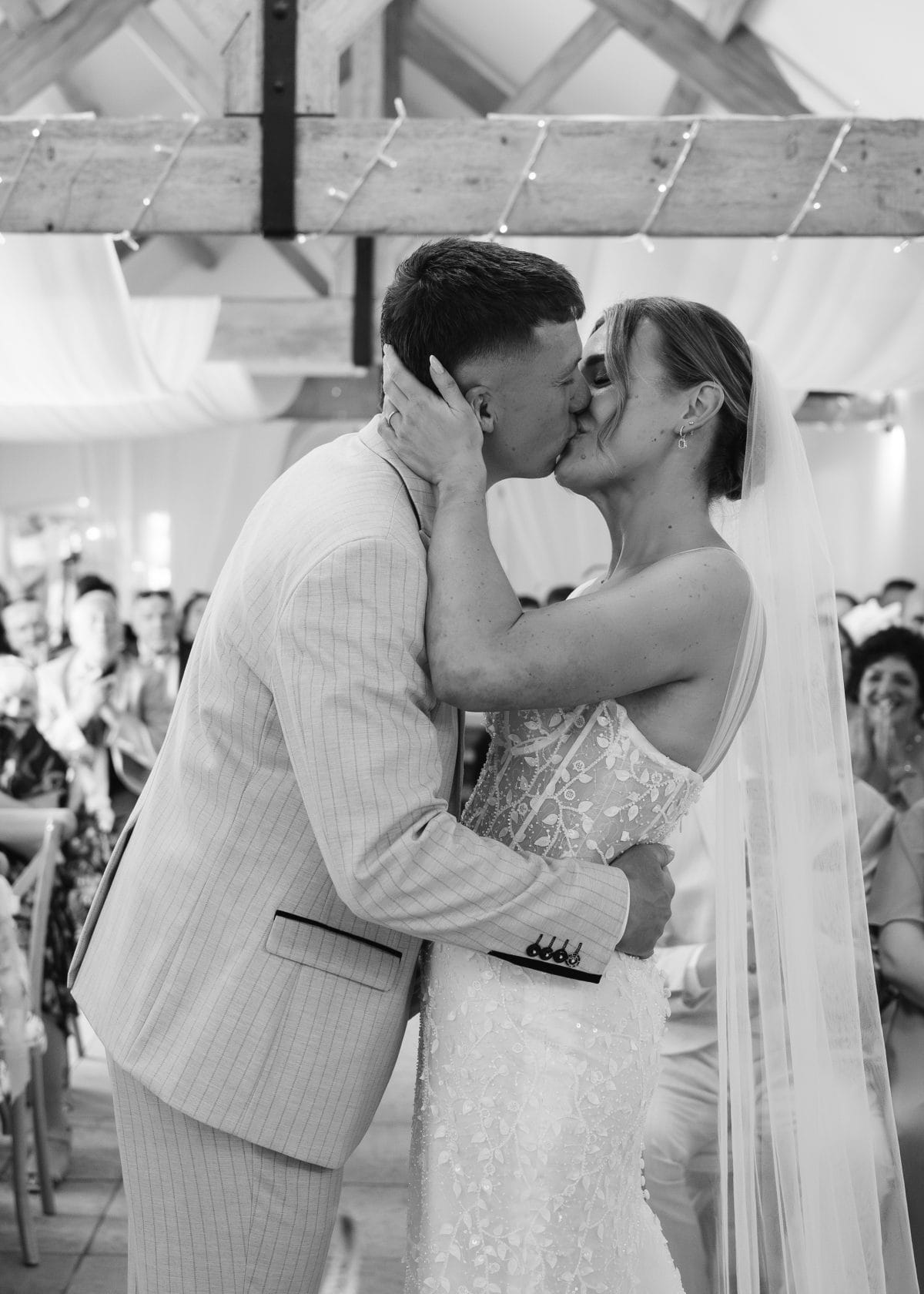Black and White couple kissing at the alter