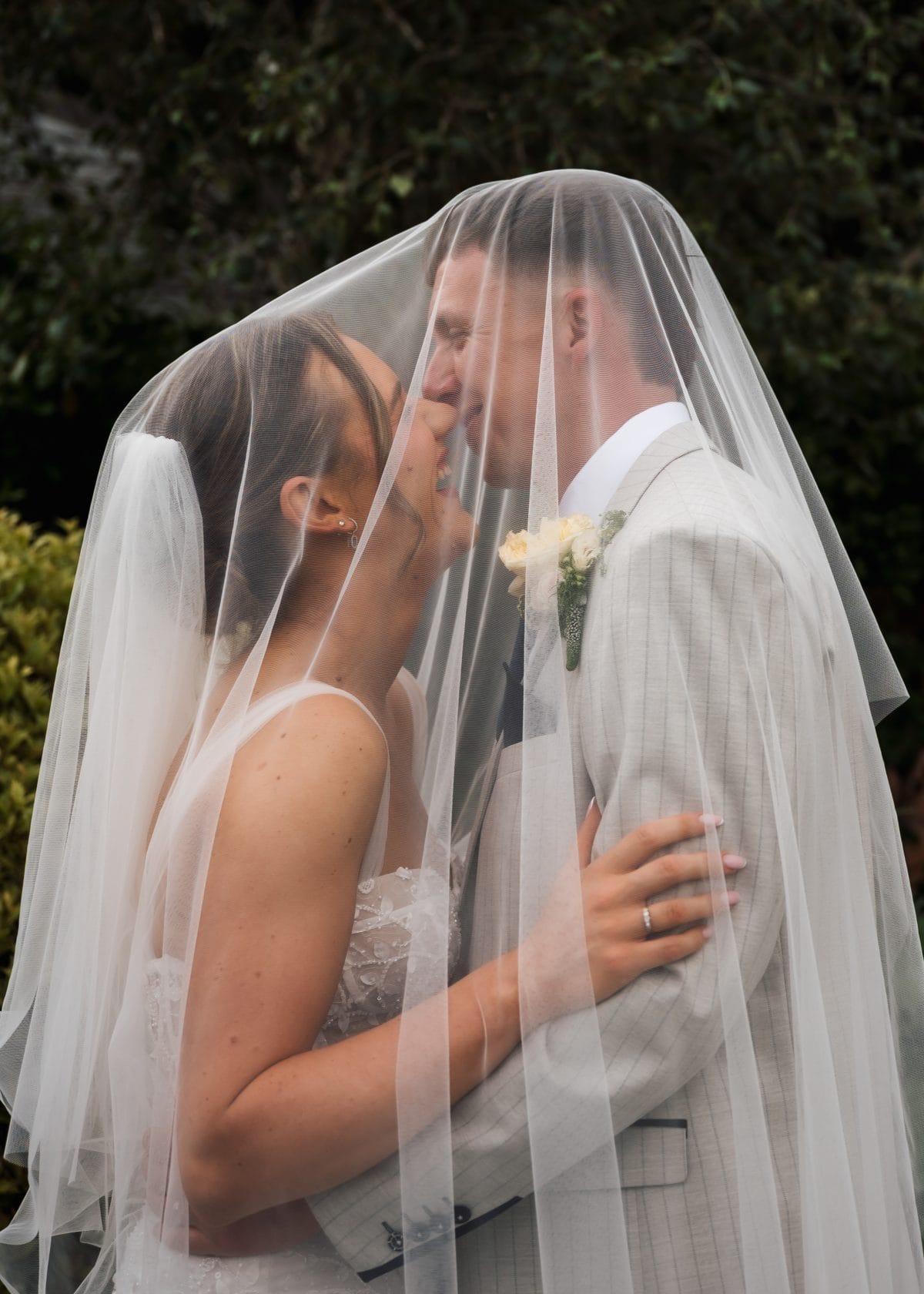 Couple under a veil laughing