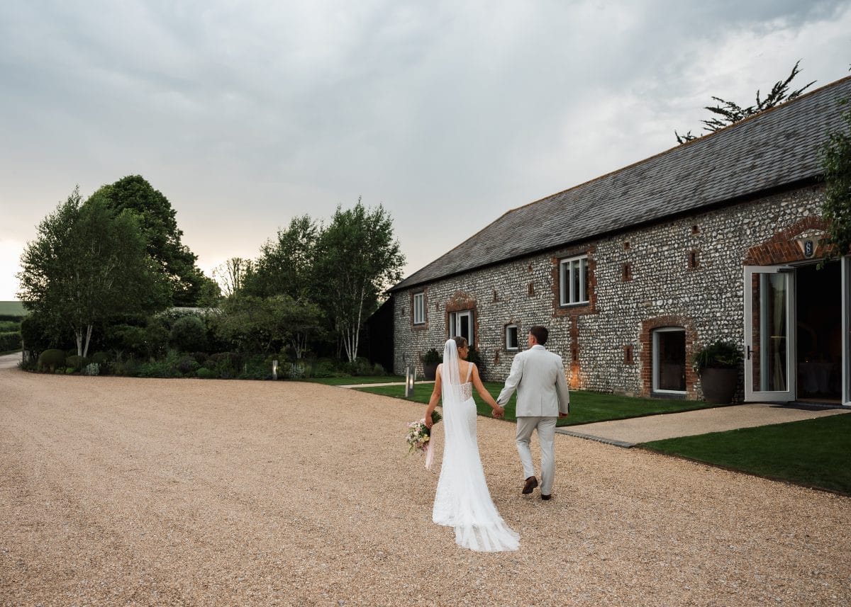 Couple walking in front of wedding venue
